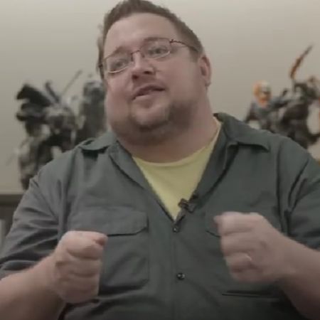 C. B. Cebulski has both his hands tightened like a fist as he is talking.